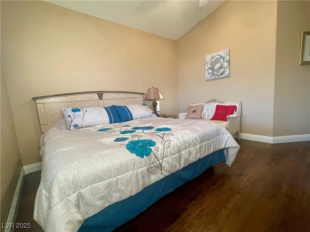 bedroom with vaulted ceiling and dark hardwood / wood-style floors