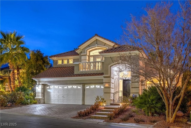 mediterranean / spanish home featuring a garage