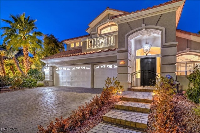 mediterranean / spanish home featuring a garage