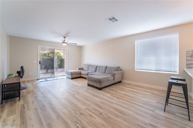 living room featuring ceiling fan and light wood-type flooring