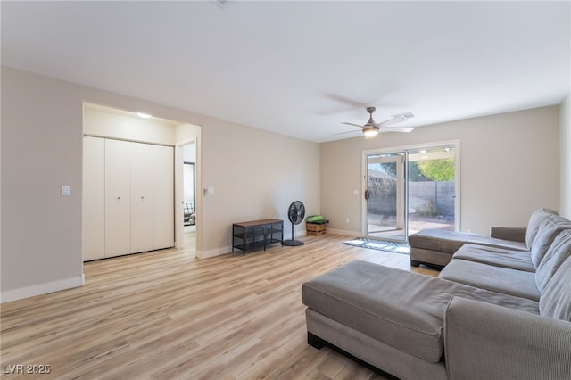 living room with ceiling fan and light hardwood / wood-style floors