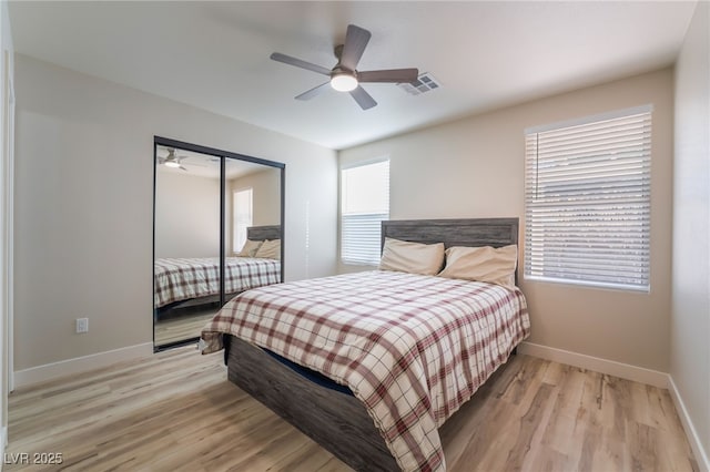 bedroom with a closet, ceiling fan, and light hardwood / wood-style flooring