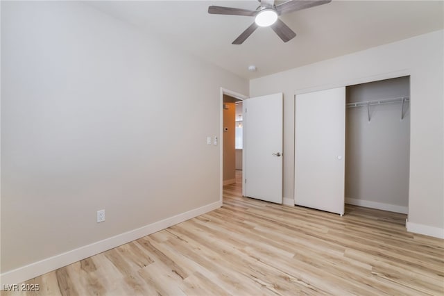 unfurnished bedroom with light hardwood / wood-style floors, a closet, and ceiling fan