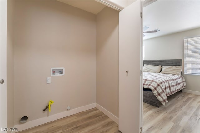 interior space with hookup for a gas dryer, hookup for a washing machine, and light wood-type flooring