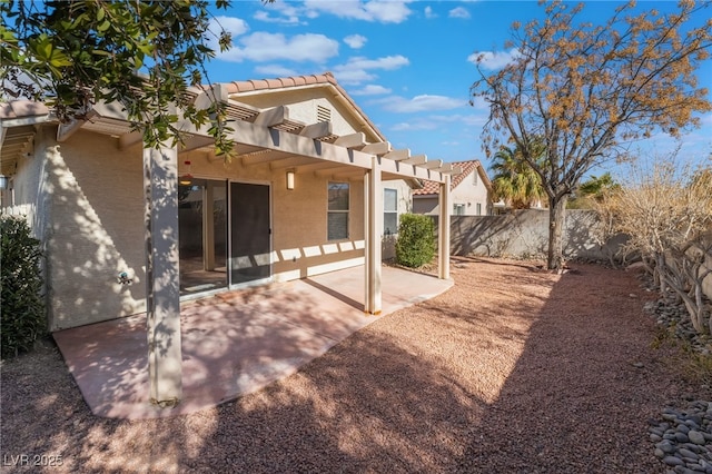 rear view of property featuring a patio and a pergola