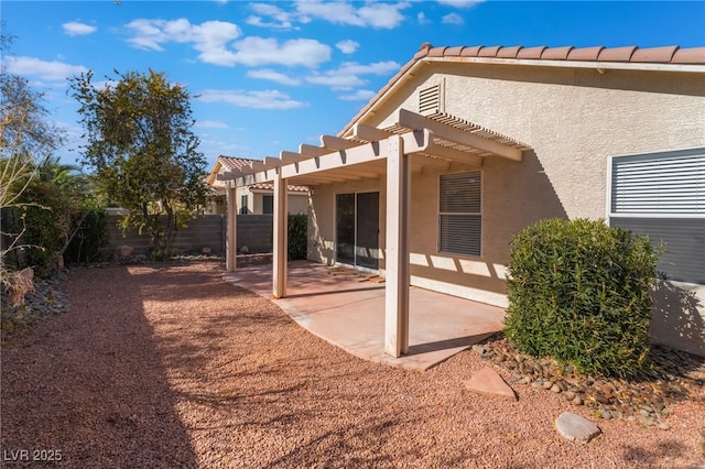 rear view of house with a pergola and a patio area