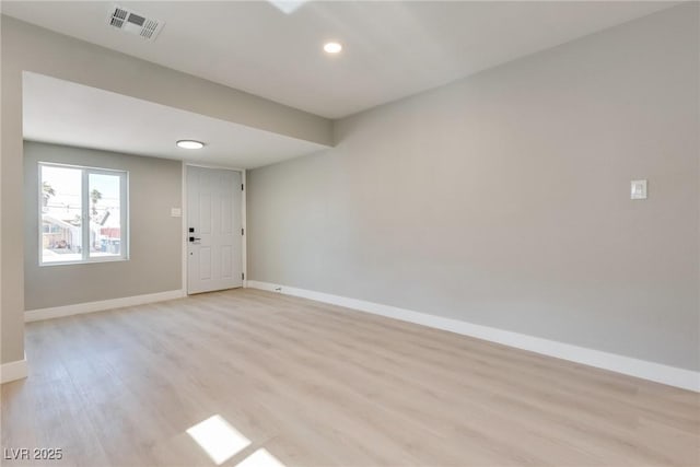 empty room with light hardwood / wood-style floors