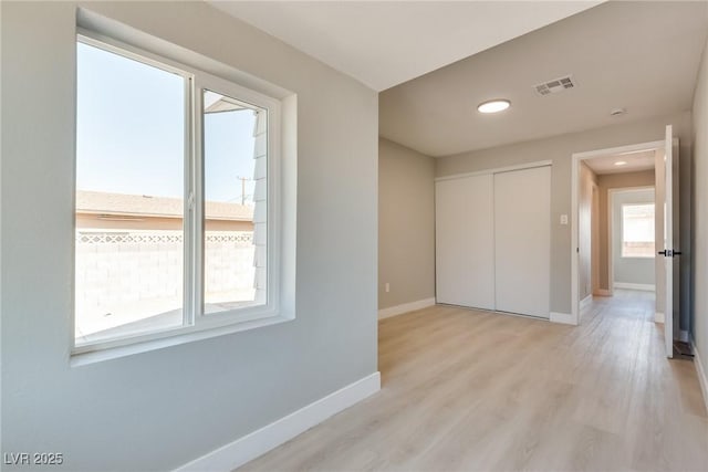 unfurnished room with light hardwood / wood-style floors