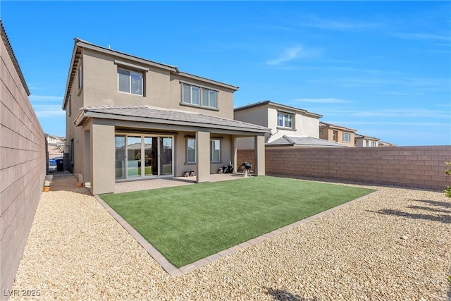 back of house featuring a patio area, stucco siding, a lawn, and fence