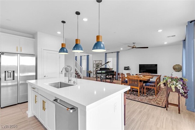 kitchen featuring a sink, light countertops, appliances with stainless steel finishes, and recessed lighting