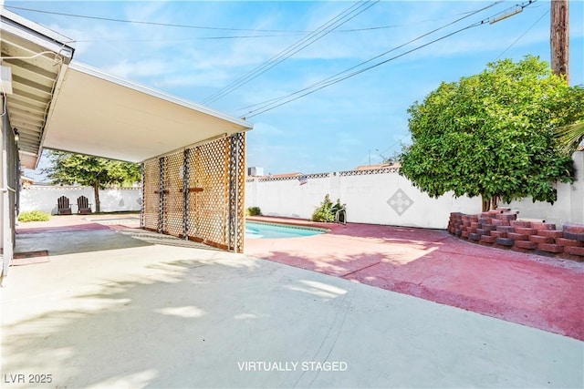 view of patio / terrace with driveway and a fenced backyard