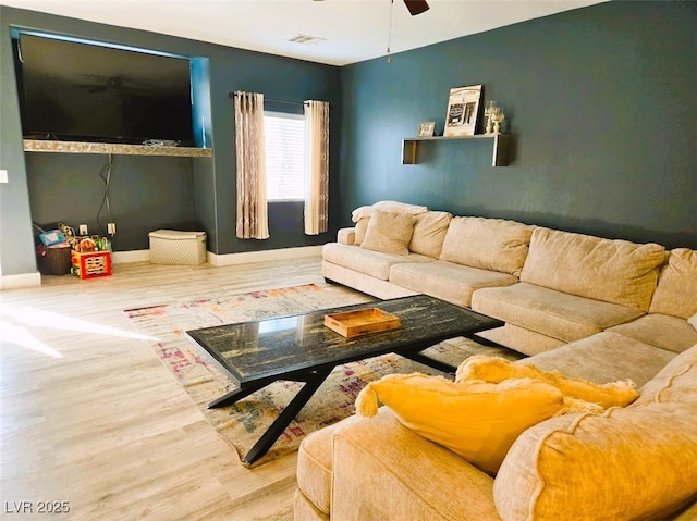 living room featuring hardwood / wood-style flooring and ceiling fan