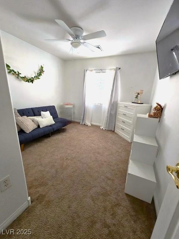 sitting room featuring carpet and ceiling fan