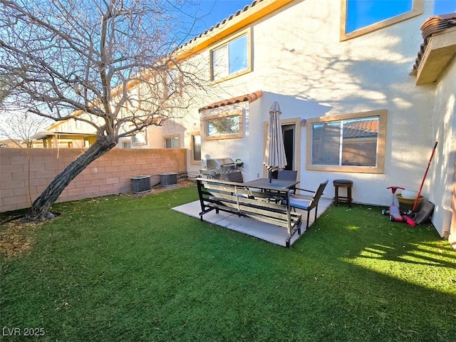 rear view of property featuring a yard, a patio area, and cooling unit