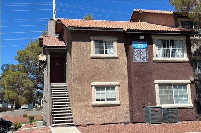 view of side of home with central AC