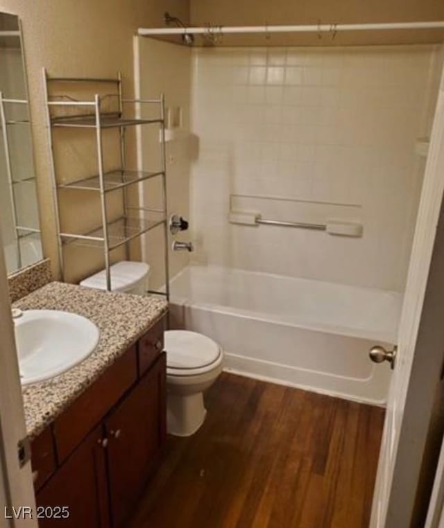 full bathroom with vanity, hardwood / wood-style flooring, toilet, and shower / bath combination