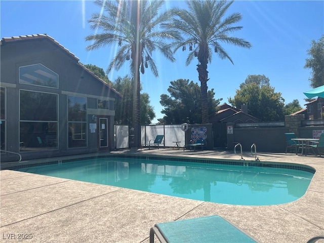 view of swimming pool with a patio