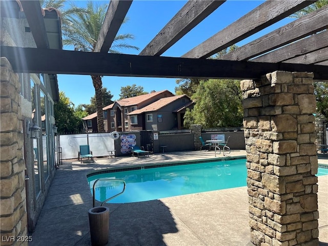 view of swimming pool with a patio area and a pergola