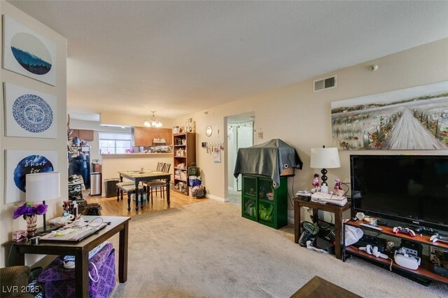 living room featuring carpet floors and a chandelier