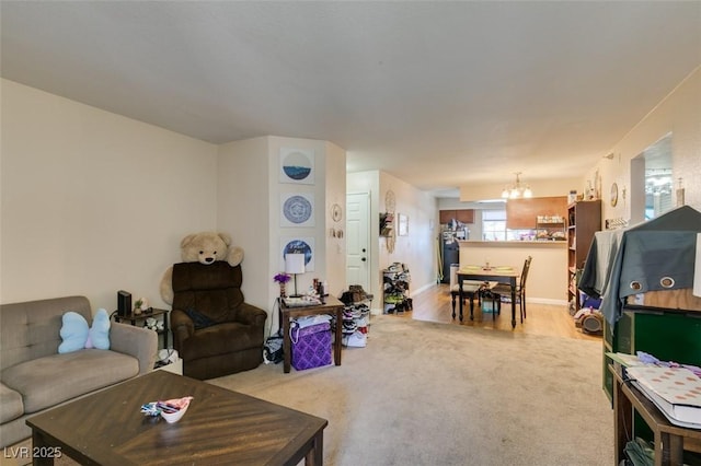 living room with an inviting chandelier and light colored carpet