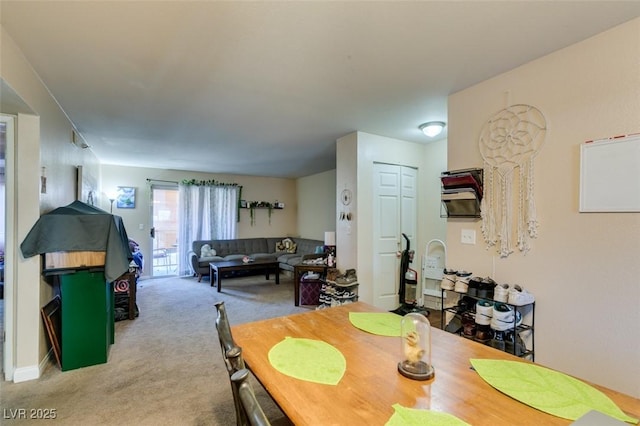 dining space featuring light colored carpet