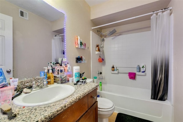 full bathroom featuring vanity, shower / tub combo, and toilet