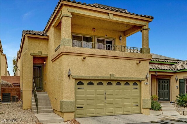 view of front of home featuring a balcony, a garage, and central air condition unit