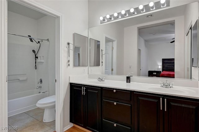 full bathroom featuring vanity, tile patterned floors, toilet, and bathtub / shower combination