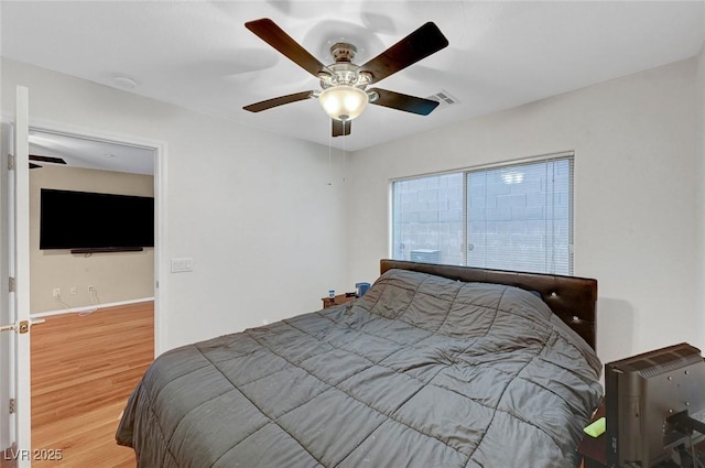 bedroom featuring wood-type flooring and ceiling fan