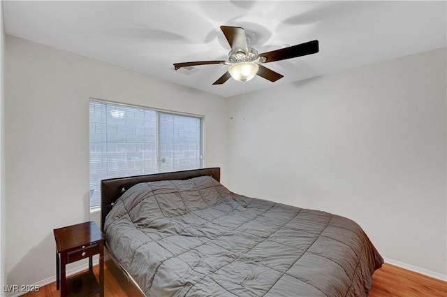 bedroom featuring wood-type flooring and ceiling fan