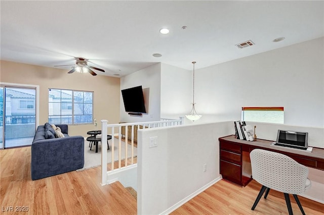 office space featuring ceiling fan and light hardwood / wood-style flooring