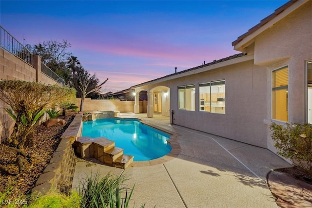 pool at dusk with a patio