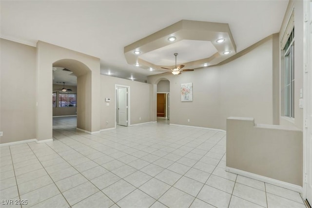 tiled spare room with ceiling fan