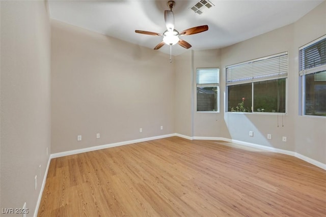 spare room with ceiling fan and light wood-type flooring