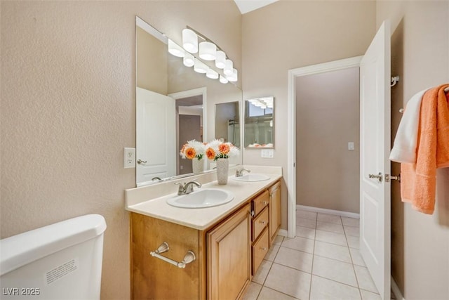 bathroom with tile patterned flooring, vanity, and toilet