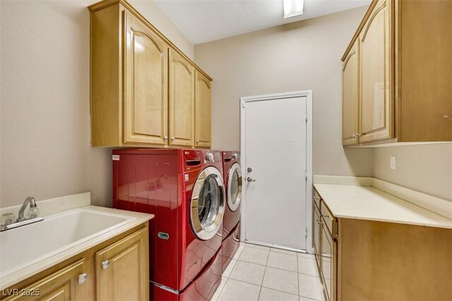 laundry room with a sink, cabinet space, independent washer and dryer, and light tile patterned flooring