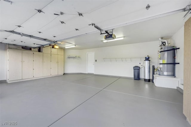 garage with a garage door opener and water heater