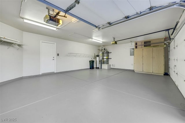 garage with a garage door opener and electric panel