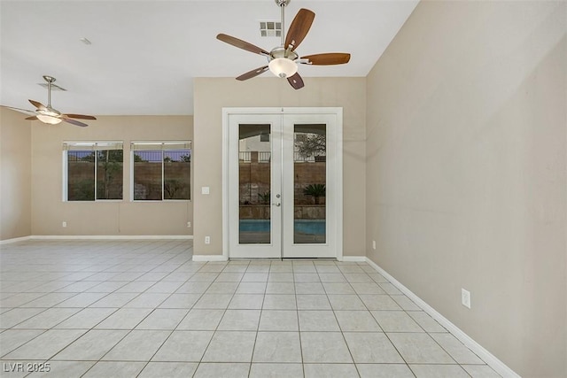 tiled spare room with french doors, ceiling fan, and a healthy amount of sunlight