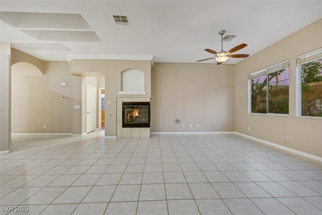 unfurnished living room featuring light tile patterned flooring, ceiling fan, and a fireplace