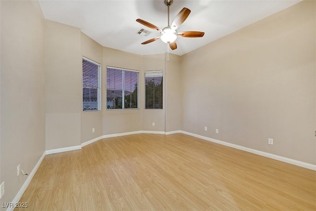 empty room featuring ceiling fan and light hardwood / wood-style flooring