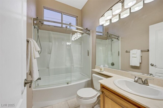 bathroom featuring vanity, tile patterned floors, toilet, and enclosed tub / shower combo