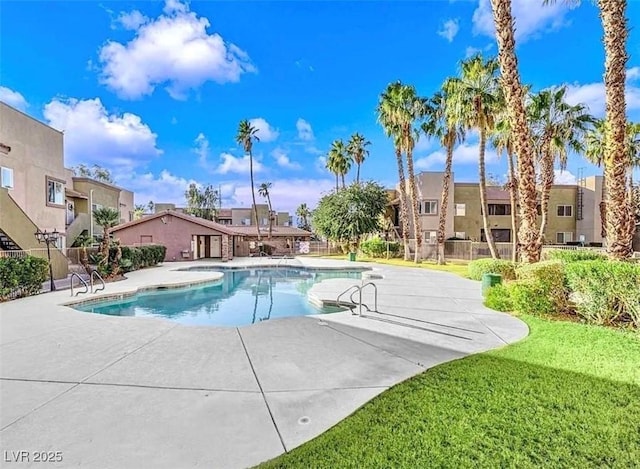 pool with a residential view, a patio, and fence