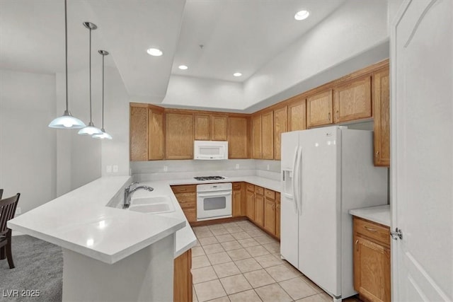 kitchen with light tile patterned flooring, sink, decorative light fixtures, kitchen peninsula, and white appliances