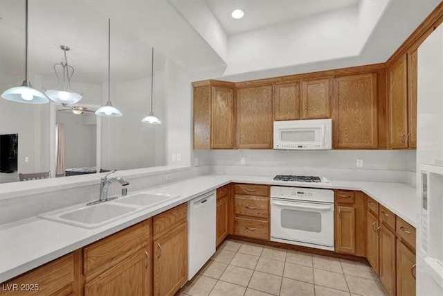 kitchen with pendant lighting, white appliances, sink, and light tile patterned floors