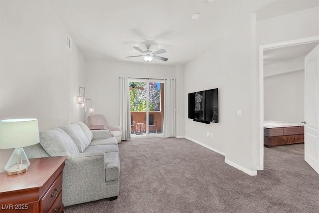 carpeted living room with ceiling fan