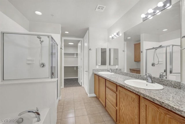 bathroom featuring an enclosed shower, vanity, and tile patterned floors