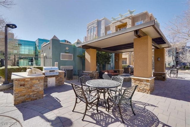 view of patio with area for grilling and an outdoor kitchen