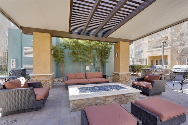 view of patio featuring area for grilling and an outdoor living space with a fire pit