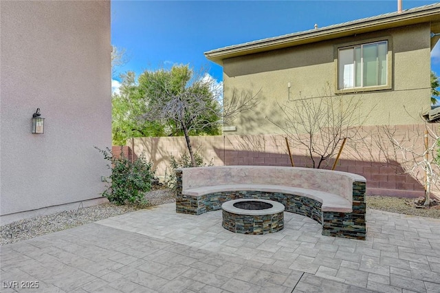 view of patio / terrace featuring an outdoor fire pit